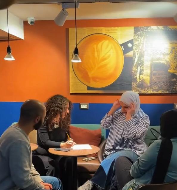 Women joining hands in a community empowerment workshop